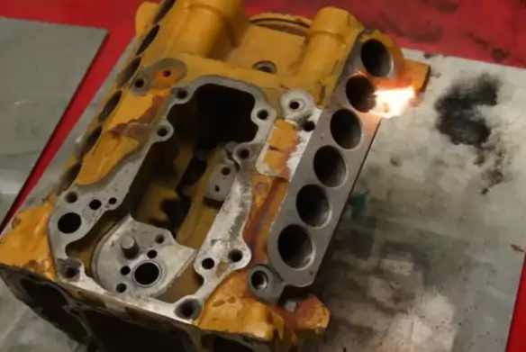 Close-up of a laser beam instantly vaporizing rust from a metal surface without damaging the base material