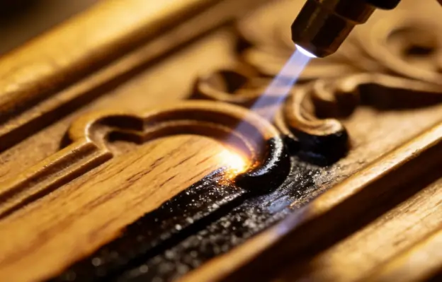 Gentle laser cleaning removing old varnish from an antique wooden panel without damaging the wood grain.