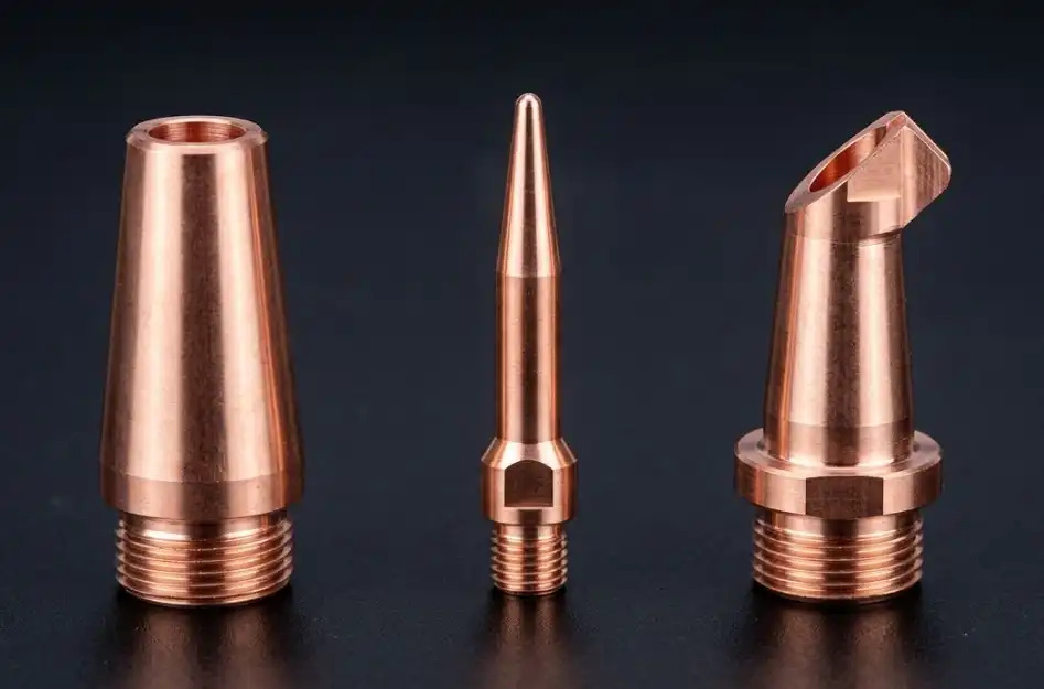 A high-quality, clean product catalog style photograph showing a row of different copper laser welding nozzles side-by-side. The lineup should include a standard conical nozzle, a narrow-gap pointed nozzle, and an angled nozzle, arranged neatly on a dark background.