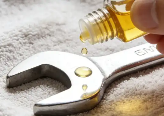 Figure 4: Applying a thin layer of protective oil to a cleaned metal tool to prevent future rust.