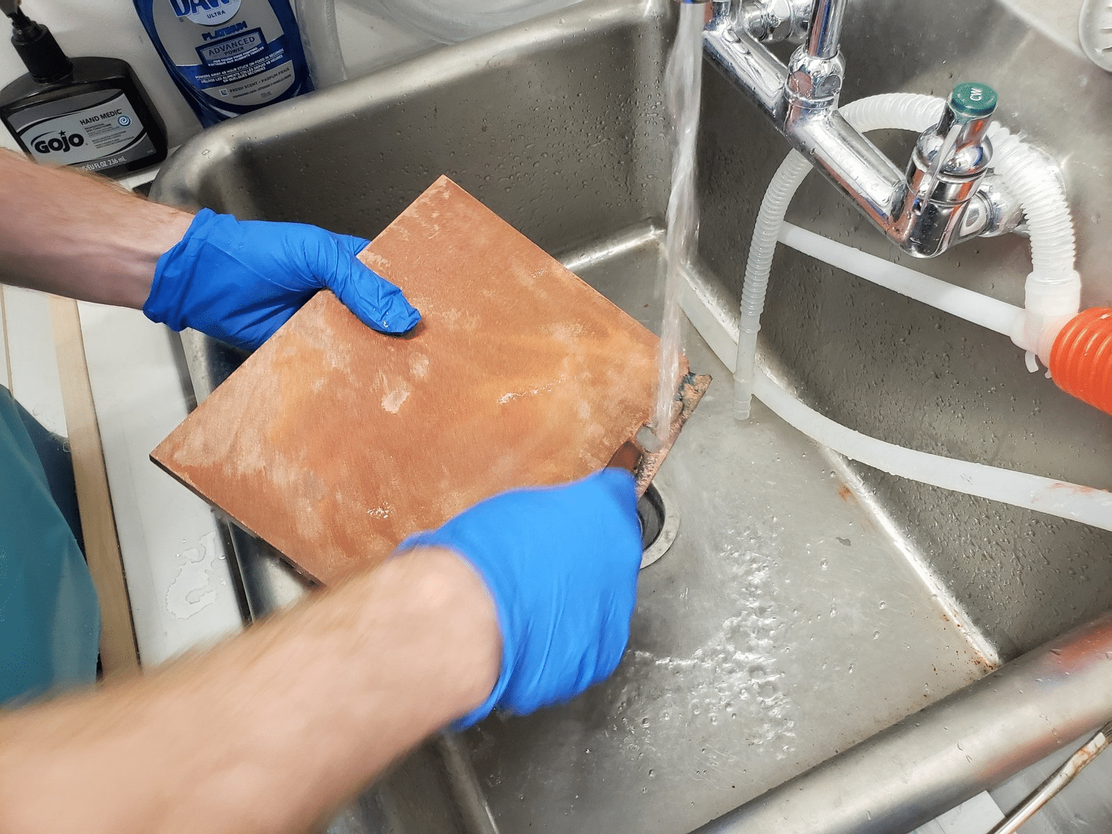 Wire brush cleaning copper plate before welding or processing